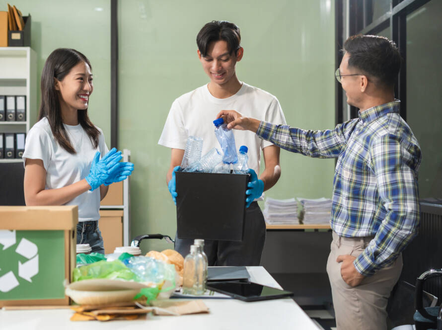 People examining waste recyclables