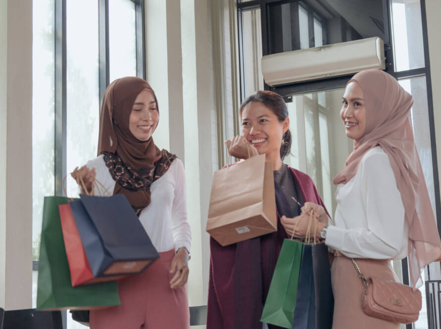 Three woman holding shopping bags